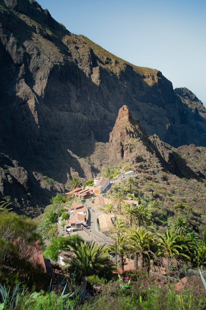 A scenic view of a secluded village nestled in the rocky landscapes of Tenerife.